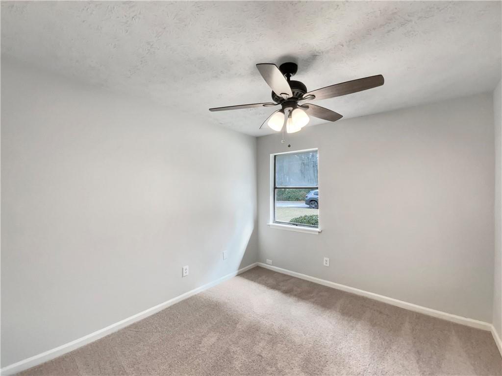 445 Wilson Mill Road Southwest Atlanta, GA 30331 - Photo 15 of 23 an empty room with a window and a fan