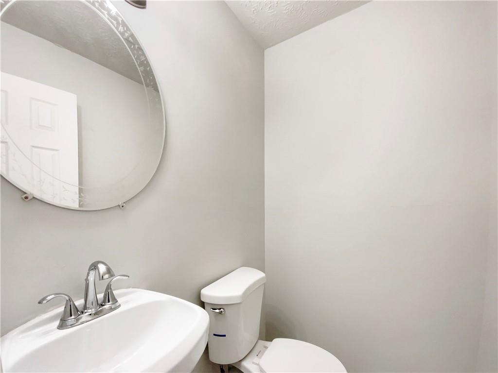 445 Wilson Mill Road Southwest Atlanta, GA 30331 - Photo 19 of 23 a white toilet sitting next to a bathroom sink