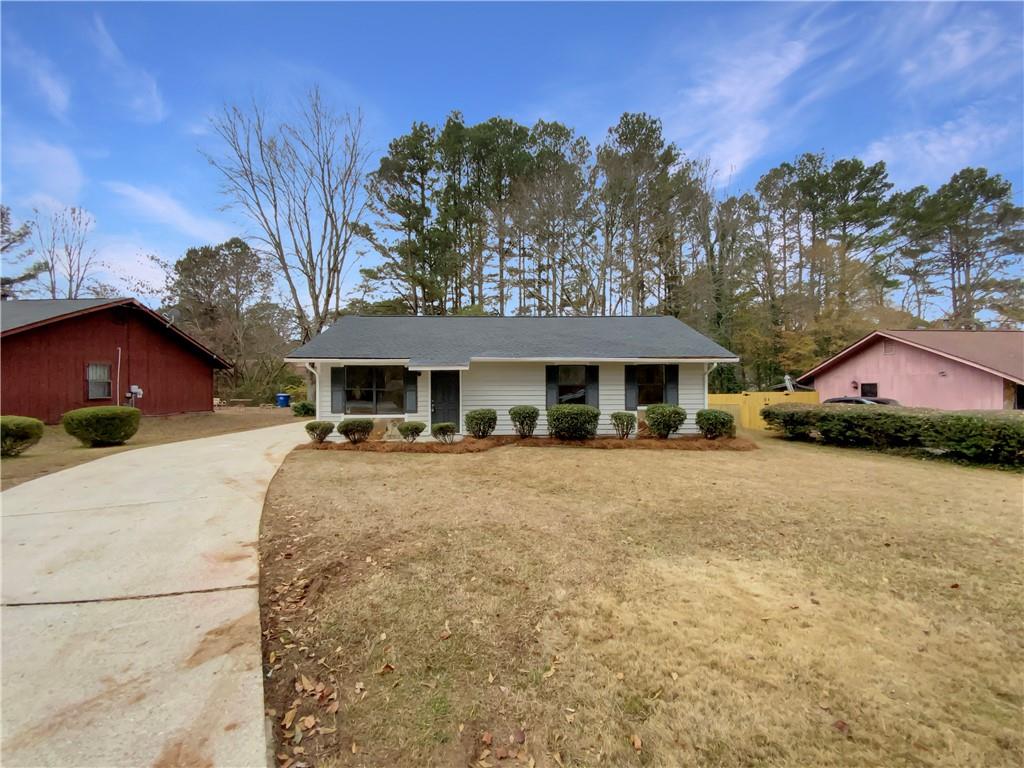 445 Wilson Mill Road Southwest Atlanta, GA 30331 - Photo 2 of 23 a front view of a house with a yard and trees
