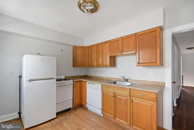 a kitchen with stainless steel appliances granite countertop a refrigerator sink and cabinets