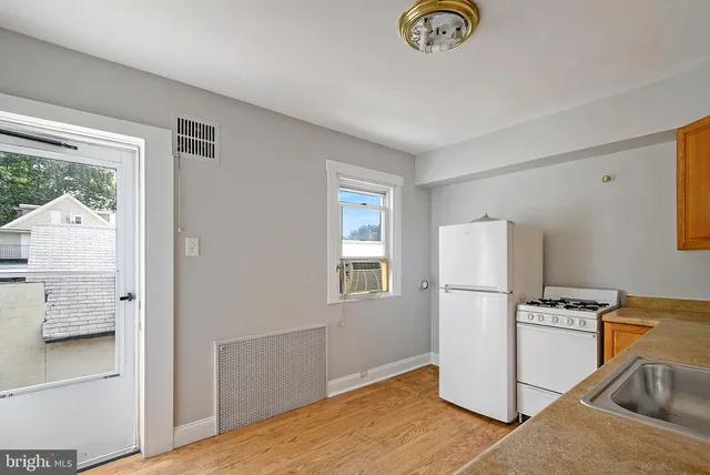 a kitchen with stainless steel appliances a refrigerator sink and cabinets