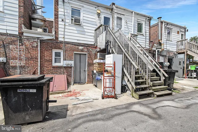 a view of front door of house with stairs