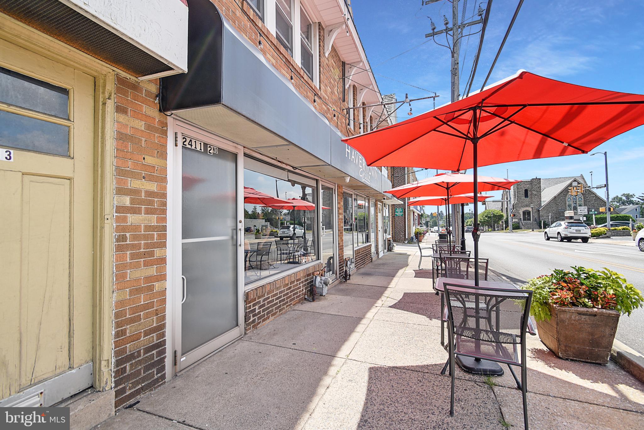 2411 West Darby Road Havertown, PA 19083 - Photo 8 of 8 a view of a patio with a table and chairs under an umbrella