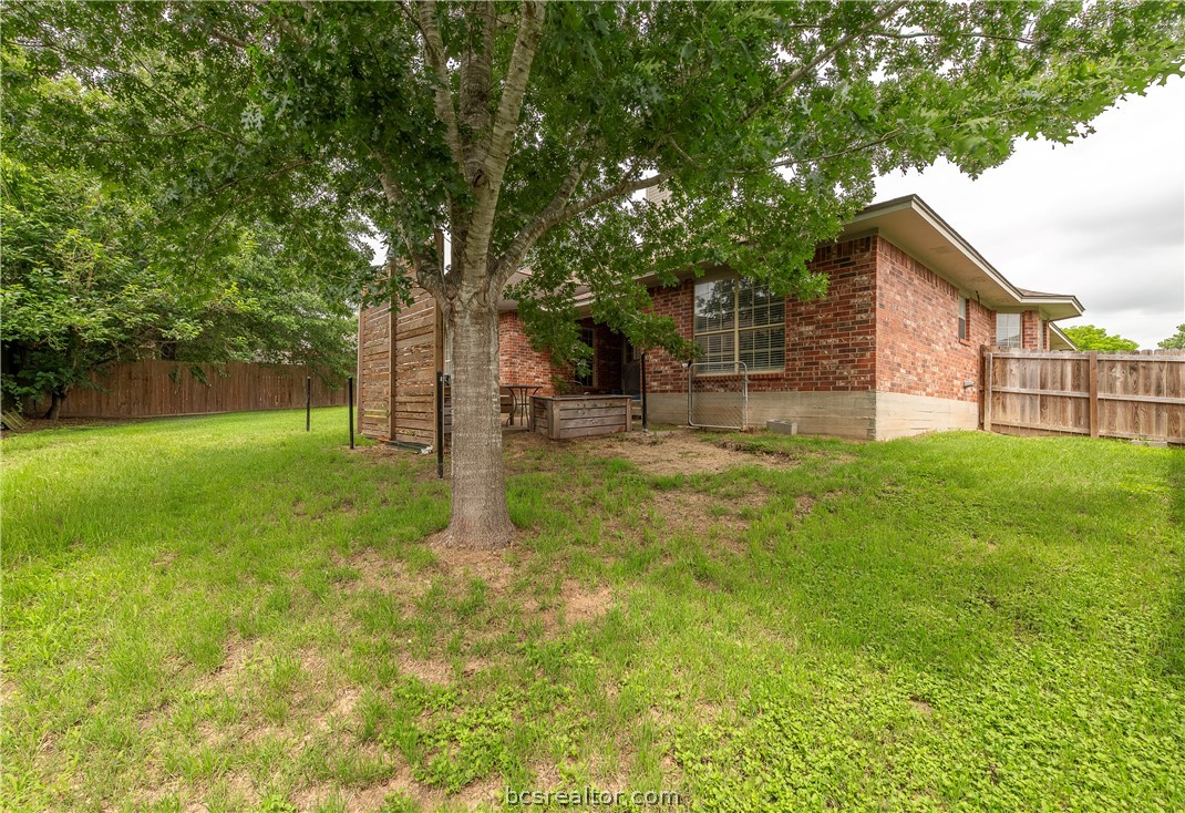 2009 Cobblestone Lane Bryan, TX 77807 - Photo 21 of 23 a backyard of a house with lots of green space