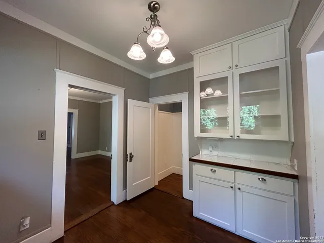 a view of wooden floor and windows in a room