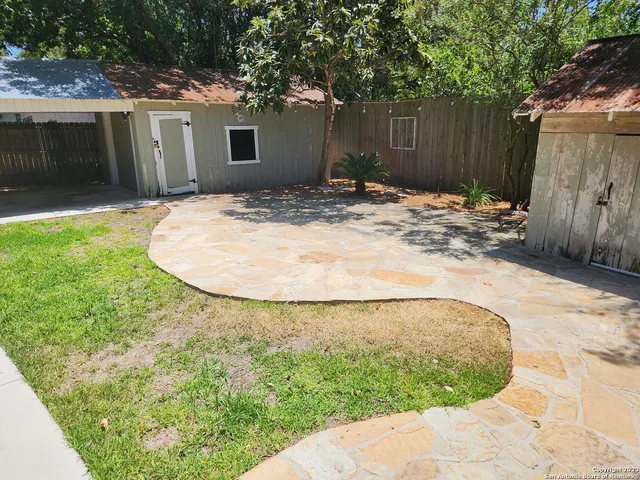 a backyard of a house with shaded area