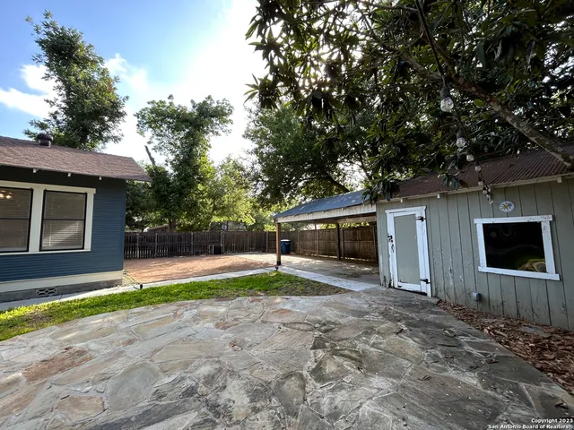 a view of a backyard with large trees