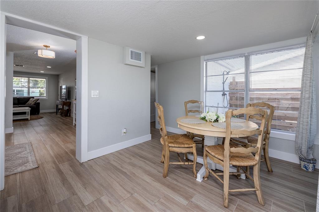 54 Rivershore Drive Ormond Beach, FL 32176 - Photo 13 of 38 a view of a dining room with furniture and wooden floor