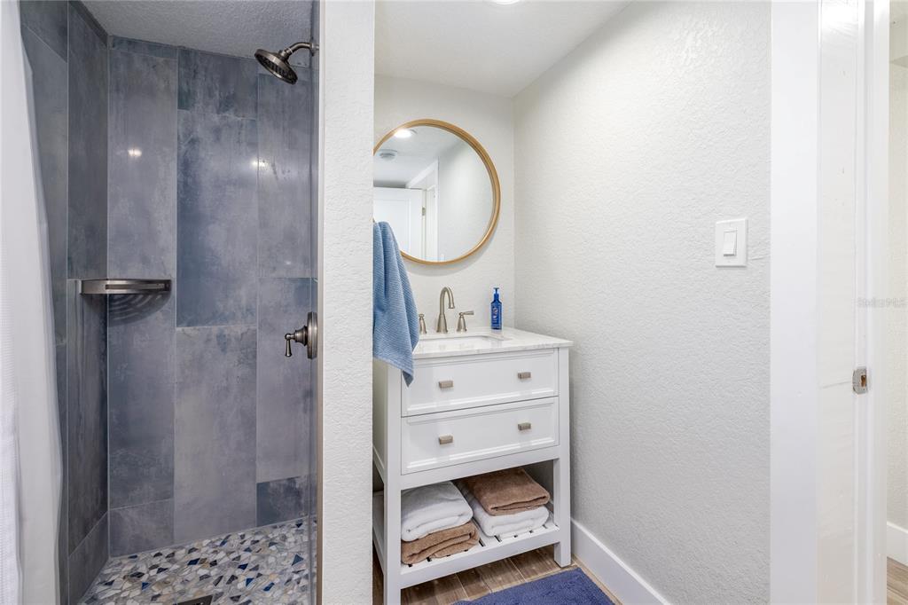 54 Rivershore Drive Ormond Beach, FL 32176 - Photo 15 of 38 a bathroom with a sink a mirror and a shower