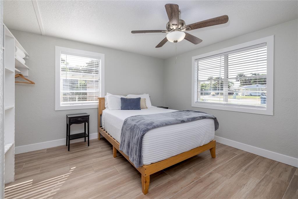 54 Rivershore Drive Ormond Beach, FL 32176 - Photo 16 of 38 a bedroom with a large bed chandelier and a window