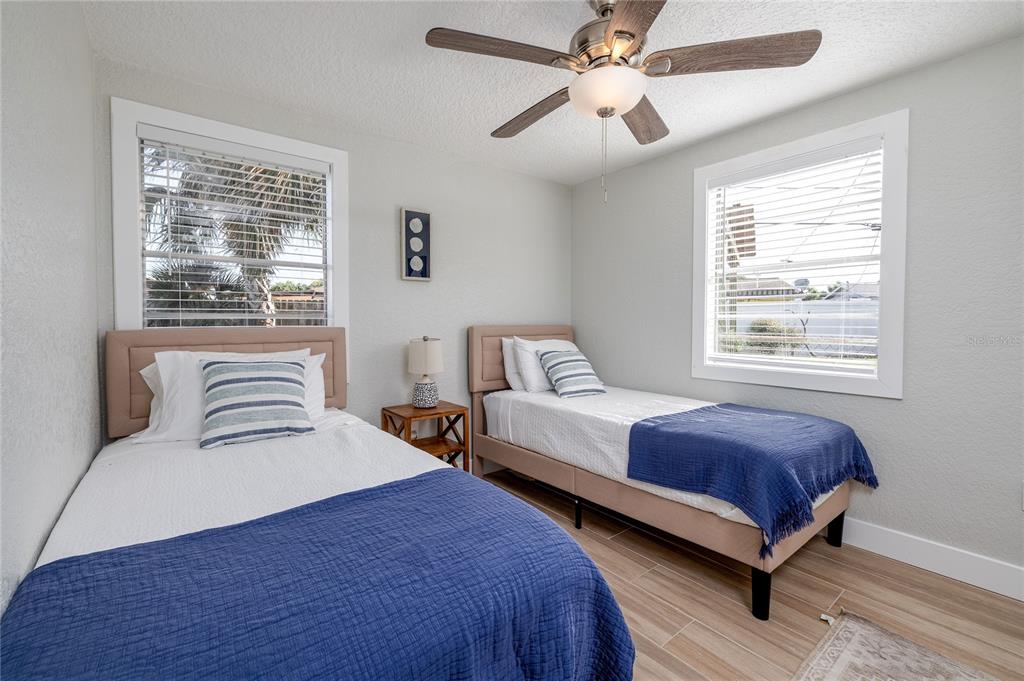 54 Rivershore Drive Ormond Beach, FL 32176 - Photo 19 of 38 a bedroom with a large bed and a chandelier