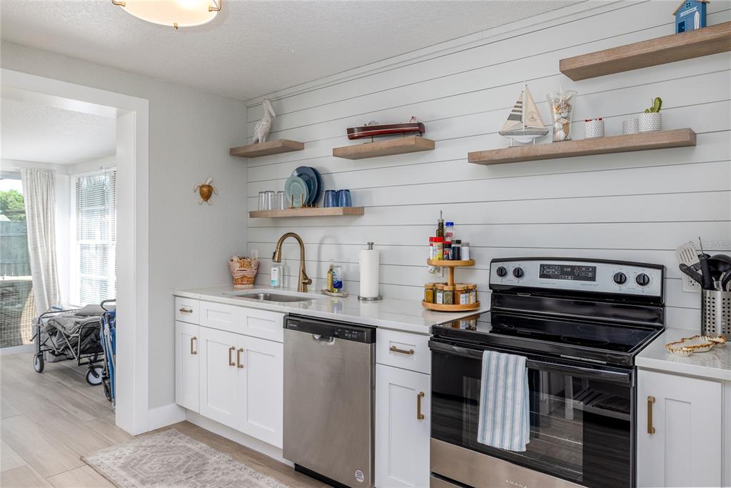 54 Rivershore Drive Ormond Beach, FL 32176 - Photo 7 of 38 a kitchen with stainless steel appliances a sink and cabinets