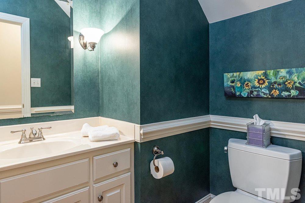 204 Reedham Way Raleigh, NC 27615 - Photo 11 of 30 Half bathroom on main level with ample storage under sink.