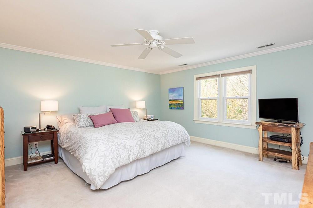 204 Reedham Way Raleigh, NC 27615 - Photo 12 of 30 Master Bedroom with double windows, ceiling fan, and crown molding.