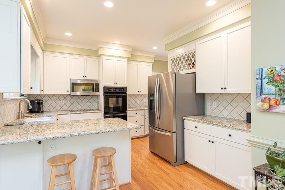 204 Reedham Way Raleigh, NC 27615 - Photo 8 of 30 Kitchen features stainless steel applainces, lots of canbinet storage, and a walk in pantry.