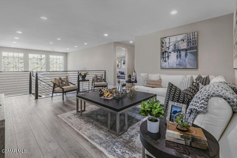 6516 Canyon Oaks Drive Simi Valley, CA 93063 - Photo 14 of 27 a living room with furniture a wooden floor and a potted plant