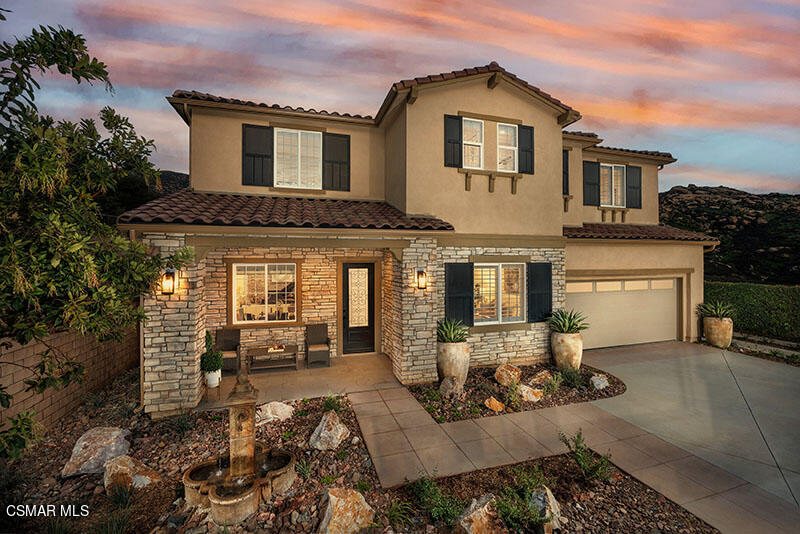 6516 Canyon Oaks Drive Simi Valley, CA 93063 - Photo 2 of 27 a front view of a house with a yard outdoor seating and garage