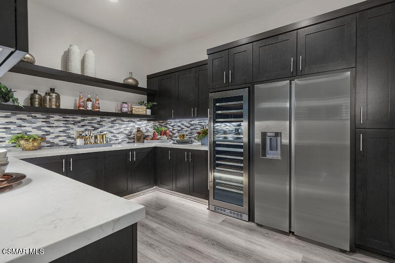 6516 Canyon Oaks Drive Simi Valley, CA 93063 - Photo 7 of 27 a kitchen with stainless steel appliances kitchen island granite countertop a refrigerator and a stove