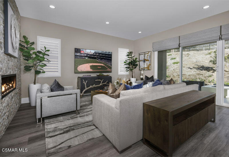 6516 Canyon Oaks Drive Simi Valley, CA 93063 - Photo 10 of 27 a living room with furniture a large window and a fireplace