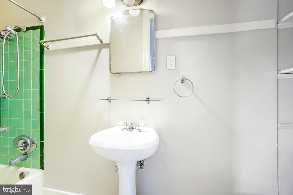 2256 Cathedral Avenue Northwest Washington, DC 20008 - Photo 11 of 23 a bathroom with a sink and mirror