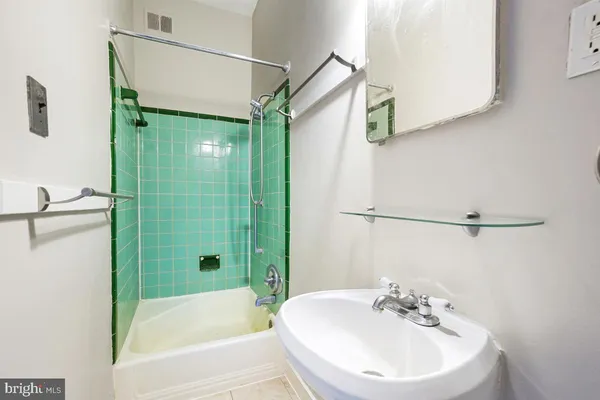 a bathroom with a sink a mirror and a shower