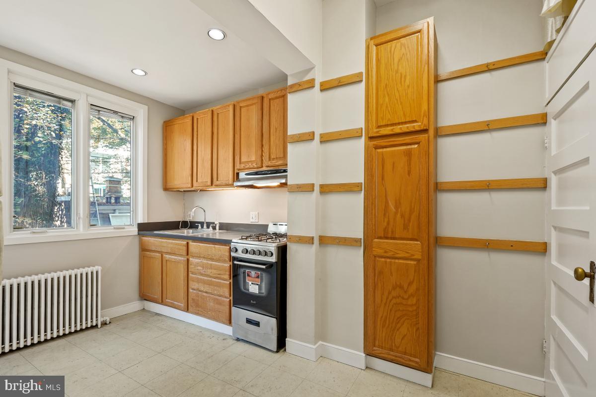 2256 Cathedral Avenue Northwest Washington, DC 20008 - Photo 13 of 23 a kitchen with stainless steel appliances granite countertop a refrigerator and a stove