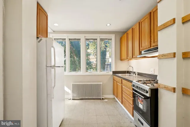 a kitchen with granite countertop a sink and a stove top oven