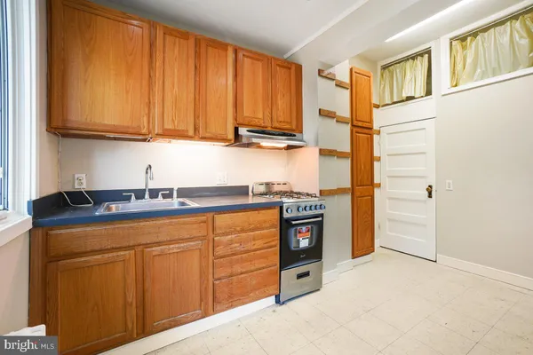 a kitchen with stainless steel appliances granite countertop a refrigerator and cabinets