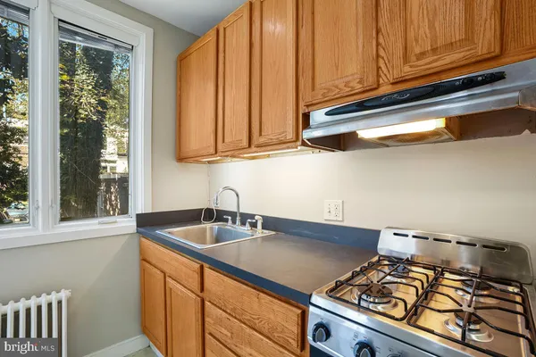 a kitchen with stainless steel appliances granite countertop a sink and a stove