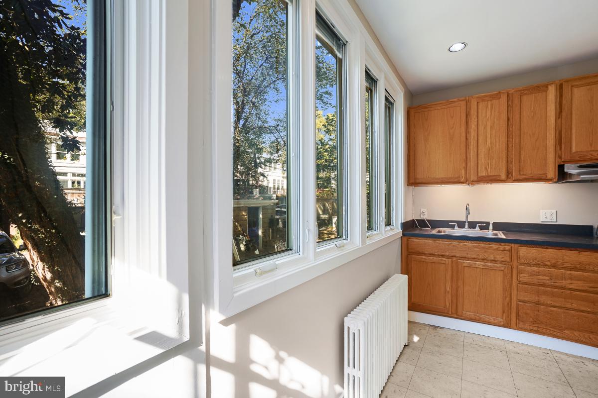 2256 Cathedral Avenue Northwest Washington, DC 20008 - Photo 17 of 23 a kitchen with stainless steel appliances granite countertop a stove a sink and a microwave