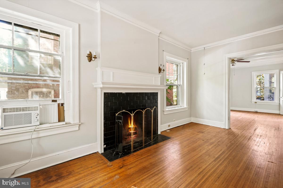 2256 Cathedral Avenue Northwest Washington, DC 20008 - Photo 5 of 23 a view of an empty room with wooden floor and a window