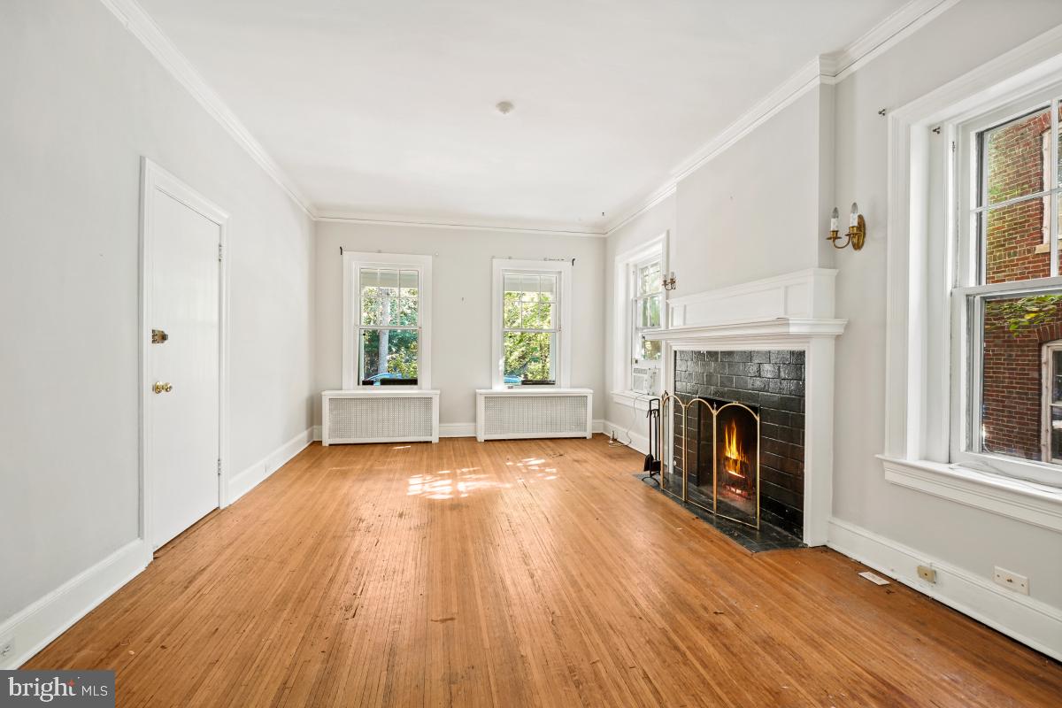 2256 Cathedral Avenue Northwest Washington, DC 20008 - Photo 6 of 23 a view of an empty room with a fireplace and a window