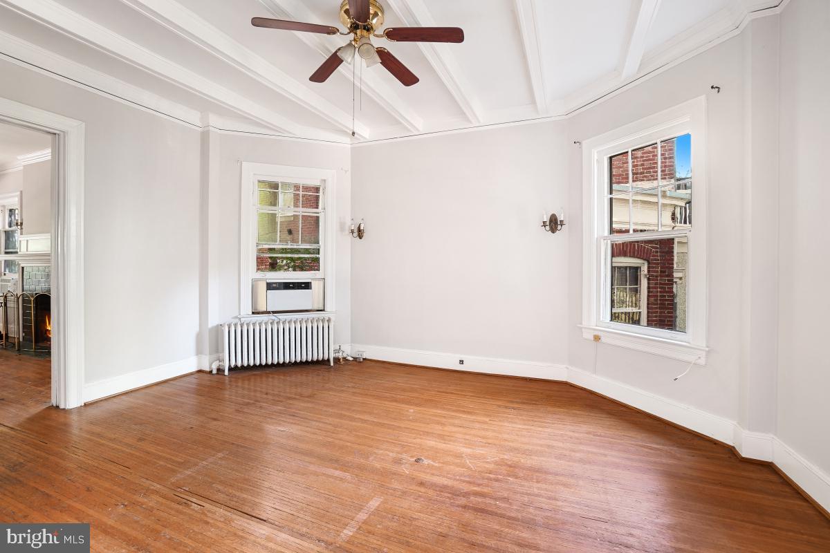 2256 Cathedral Avenue Northwest Washington, DC 20008 - Photo 9 of 23 a view of an empty room with a window and wooden floor