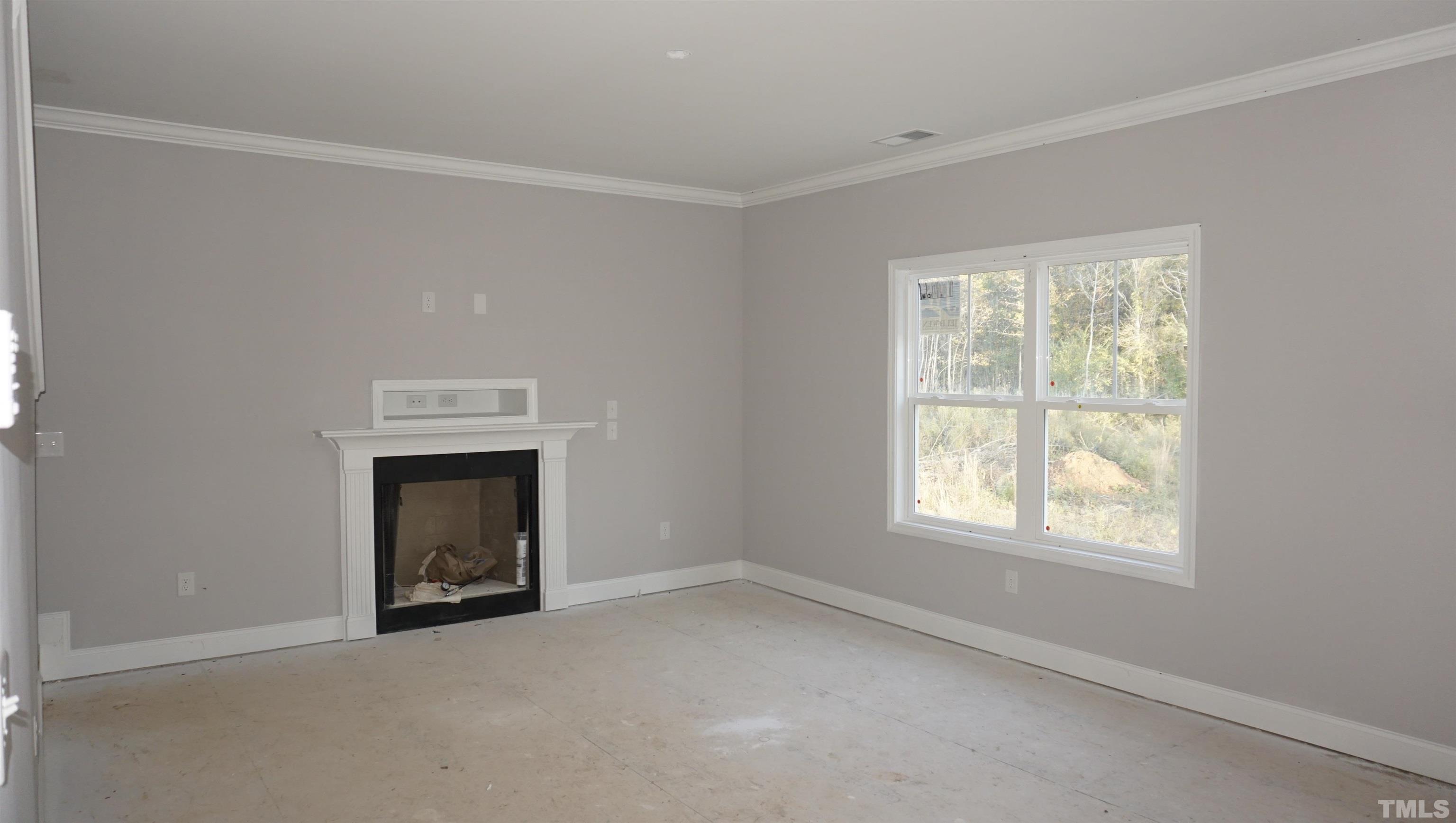 10645 West Old Spring Hope Road Spring Hope, NC 27882 - Photo 4 of 13 a view of an empty room with a window and fireplace