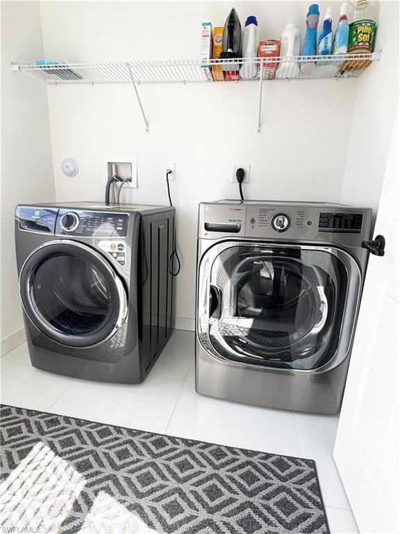 8984 Madrid Circle Naples, FL 34104 - Photo 11 of 28 a utility room with dryer and washer