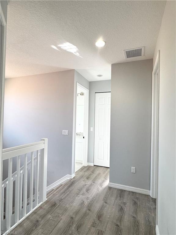 8984 Madrid Circle Naples, FL 34104 - Photo 16 of 28 a view of entryway with wooden floor