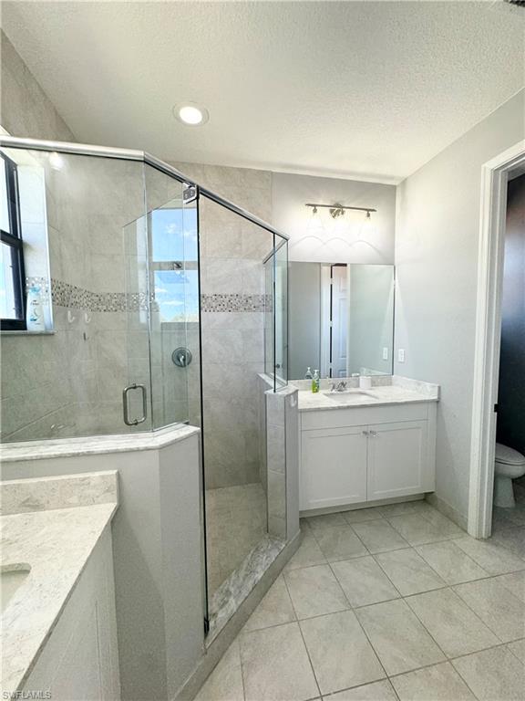 8984 Madrid Circle Naples, FL 34104 - Photo 21 of 28 a bathroom with a bathtub shower sink and mirror