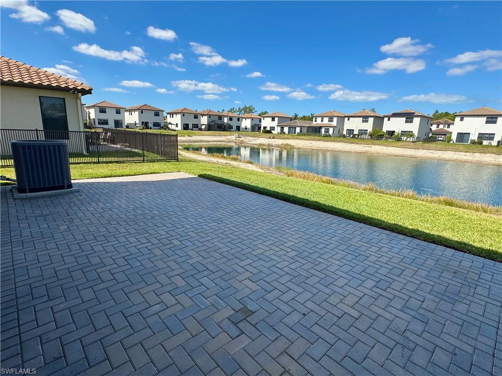 8984 Madrid Circle Naples, FL 34104 - Photo 22 of 28 a view of a swimming pool and an outdoor seating