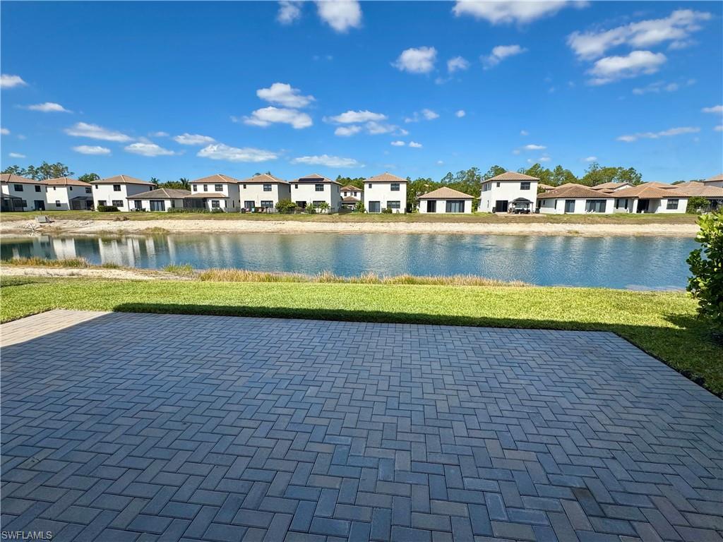 8984 Madrid Circle Naples, FL 34104 - Photo 23 of 28 a view of swimming pool with outdoor seating and yard