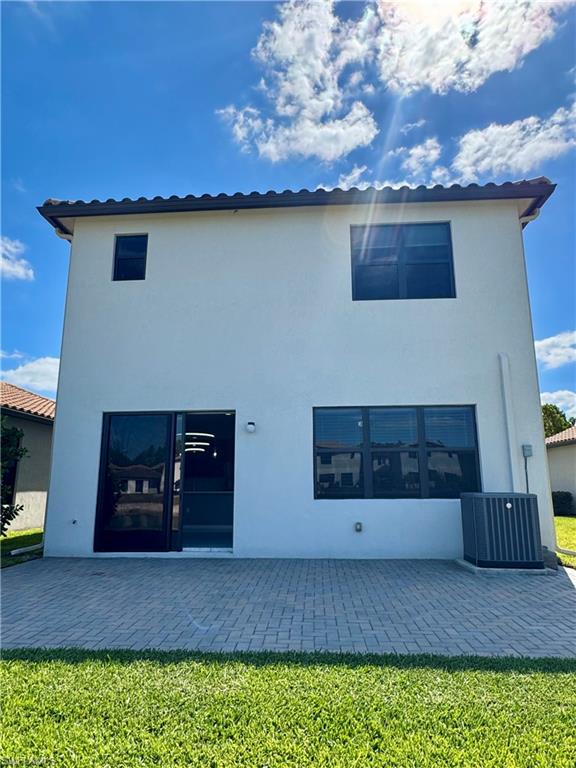 8984 Madrid Circle Naples, FL 34104 - Photo 25 of 28 a kitchen with a stove and cabinets