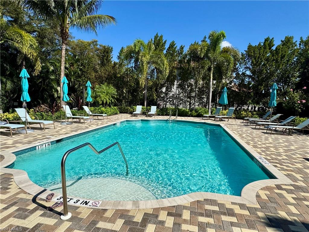 8984 Madrid Circle Naples, FL 34104 - Photo 27 of 28 a view of swimming pool from a lounge chair