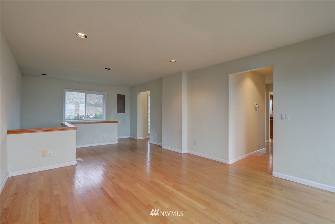 406 Stevens Avenue Northwest Renton, WA 98057 - Photo 3 of 24 an empty room with wooden floor and windows