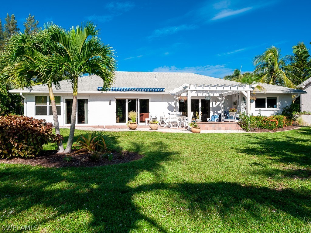 1467 Sand Castle Road Sanibel, FL 33957 - Photo 30 of 35 a front view of a house with garden