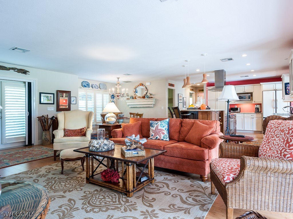 1467 Sand Castle Road Sanibel, FL 33957 - Photo 4 of 35 a living room with furniture kitchen view and a rug