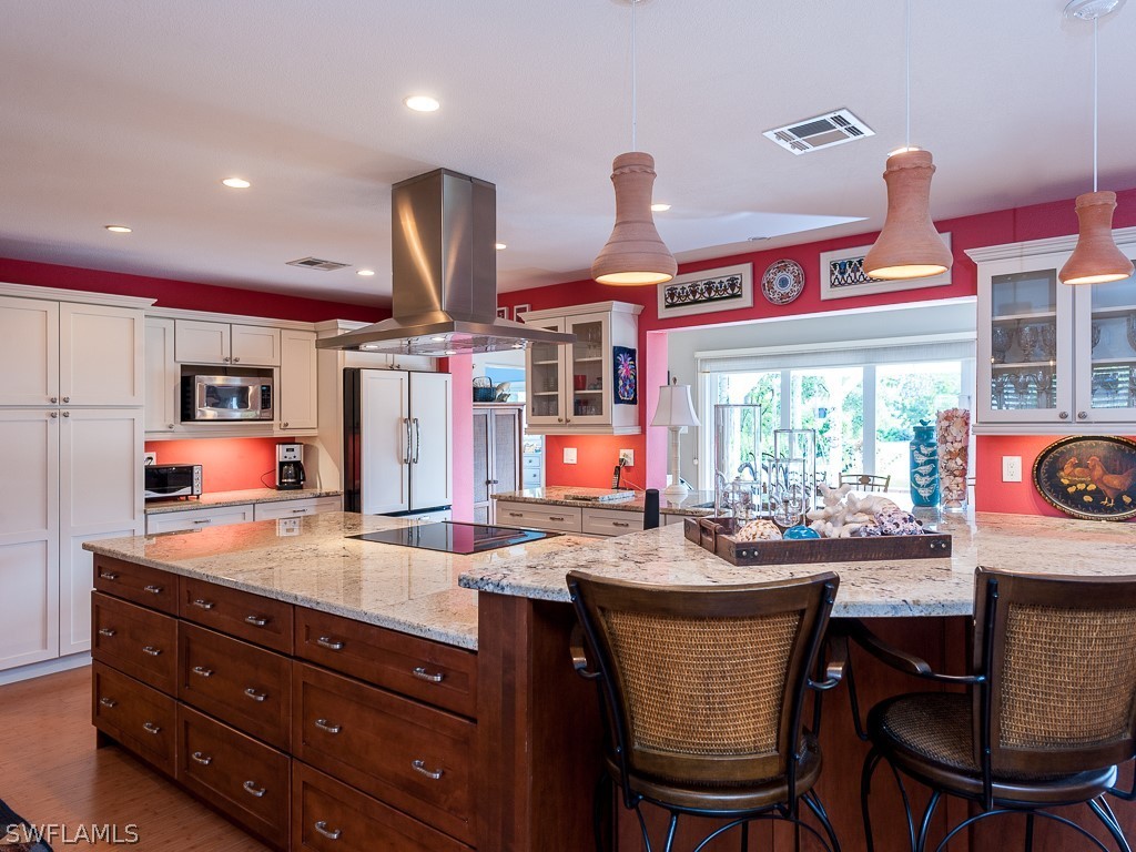 1467 Sand Castle Road Sanibel, FL 33957 - Photo 9 of 35 a dining table with chairs and window