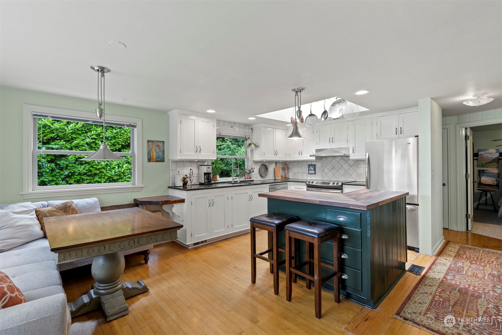 426 Lakeview Road Lynnwood, WA 98087 - Photo 14 of 33 a kitchen with a table chairs refrigerator and cabinets