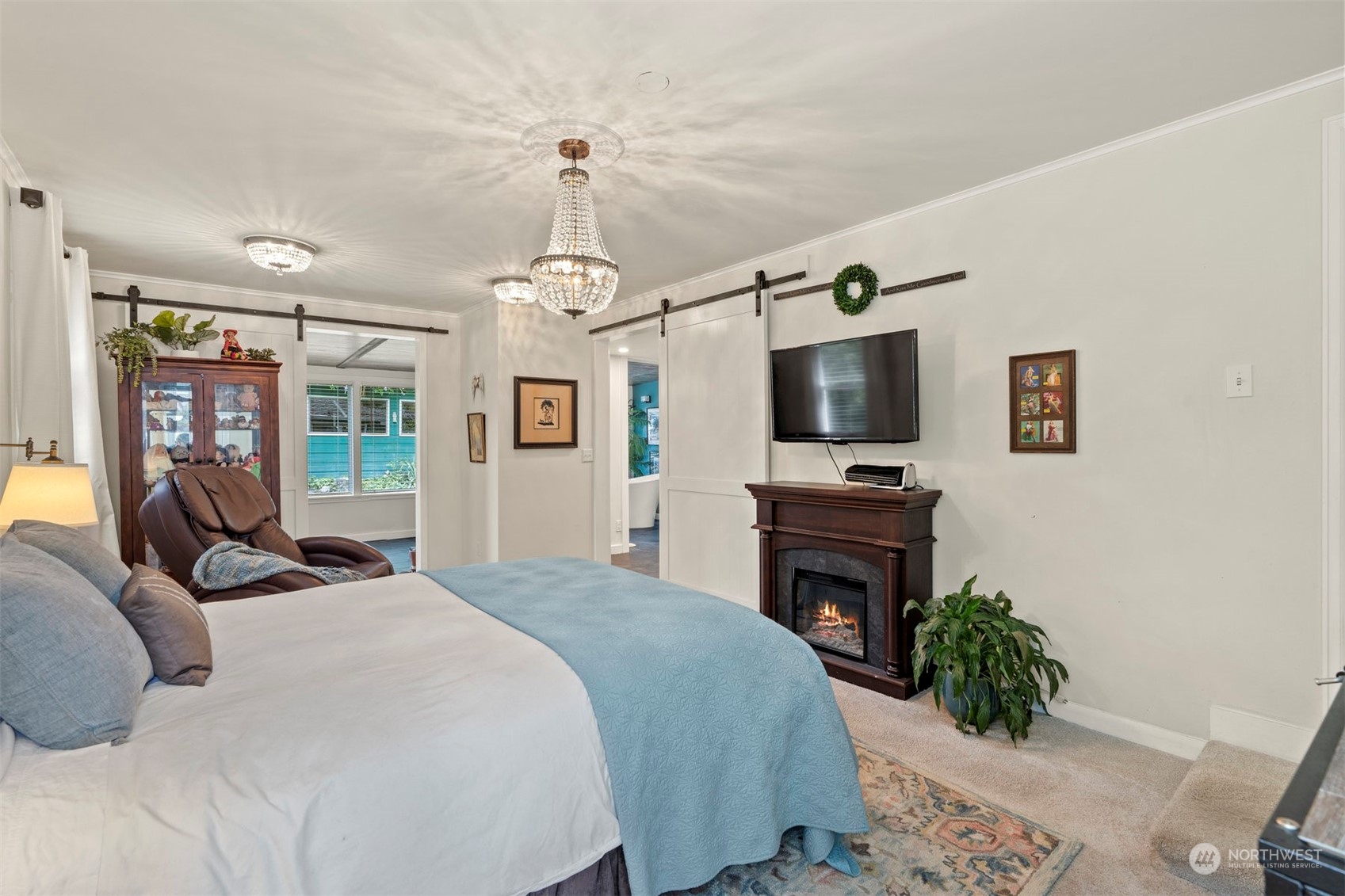 426 Lakeview Road Lynnwood, WA 98087 - Photo 19 of 33 a bedroom with a bed television and a fireplace