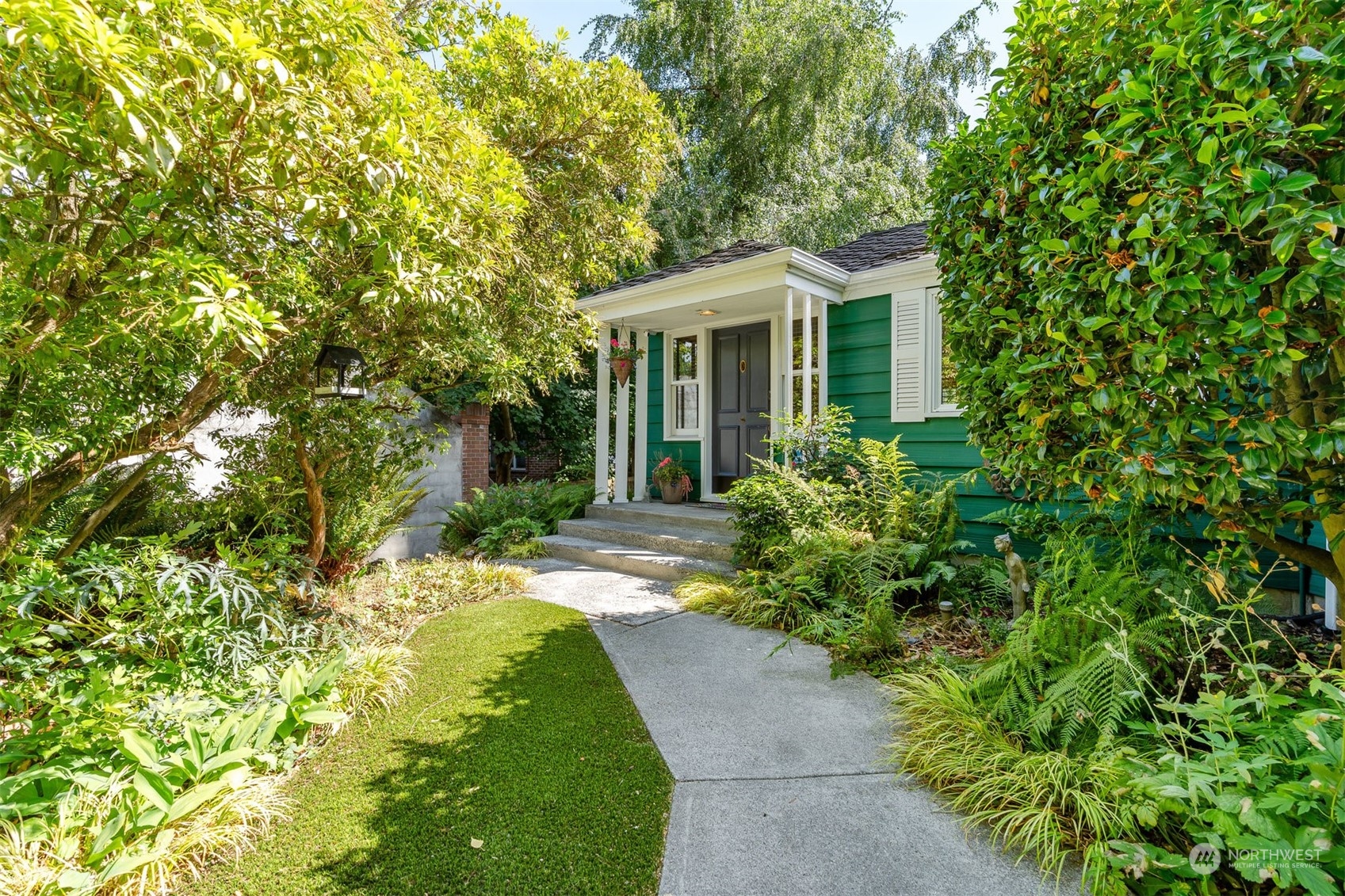 426 Lakeview Road Lynnwood, WA 98087 - Photo 7 of 33 a view of a house with potted plants and large trees