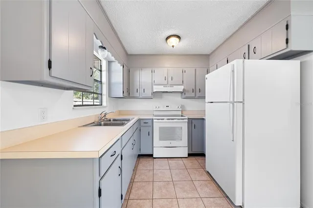 a kitchen with a white cabinets and white appliances