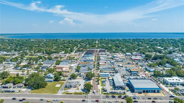 an aerial view of residential houses with outdoor space and street view